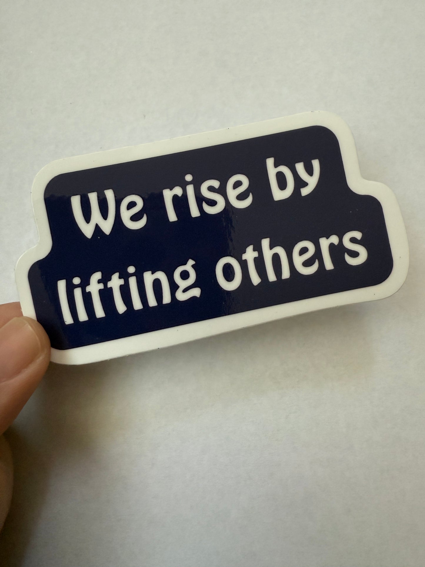 We rise by lifting others sticker